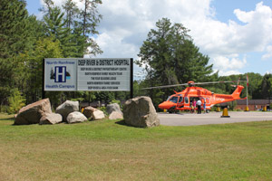 Hosptial signage with helicopter in background