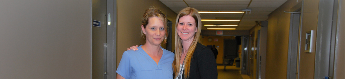 Photo of two female hospital employees in hallway